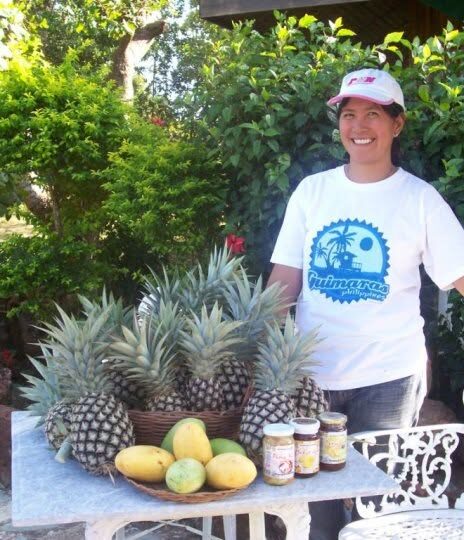 Rose Griesser beside a table of Guimaras mangoes, pineapples and the farm’s own jars